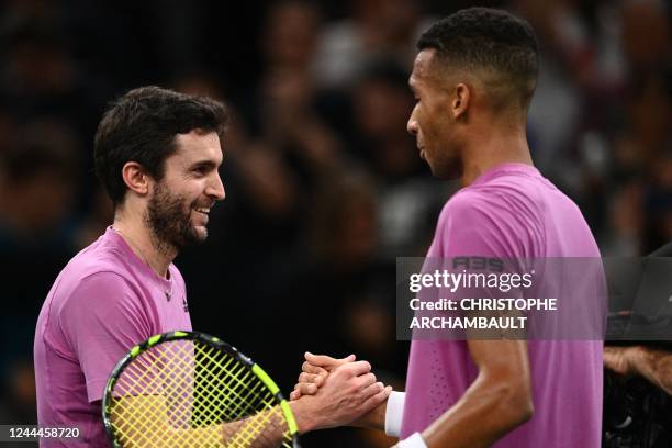 France's Gilles Simon shakes hands with Canada's Felix Auger-Aliassime at the end of their men's singles round of 8 tennis match on day four of the...