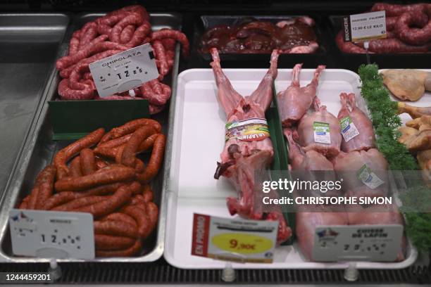 This picture taken on on November 3, 2022 shows sausages and rabbits displayed at the butcher department in a supermarket in Septemes-les-Vallons...