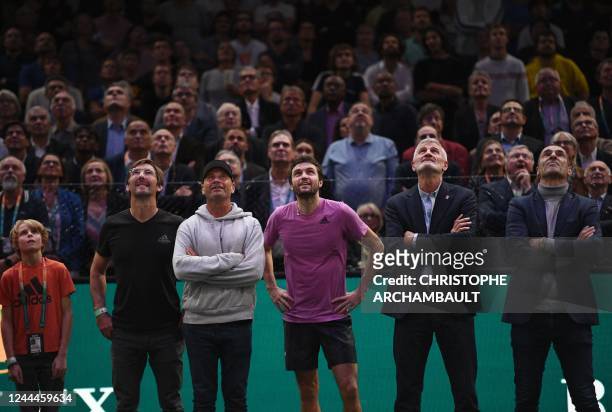 France's Gilles Simon poses with his son Thimothee Simon , his former coaches and President of the French Tennis Federation Gilles Moretton as he...