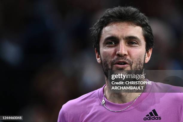 France's Gilles Simon reacts as he attends a ceremony marking the end of his career, after 20 years of playing, at the end of his men's singles round...