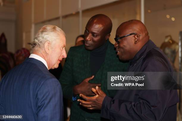 King Charles III speaks to Edward Enninful, editor-in-chief of British Vogue and British fashion designer Ozwald Boateng as he visits the "Africa...