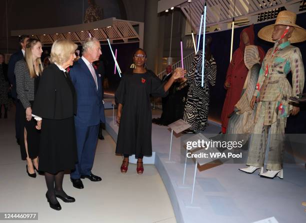 Camilla, Queen Consort, King Charles III and Curator Christine Checinska visit the "Africa Fashion" exhibition at The V&A on November 03, 2022 in...