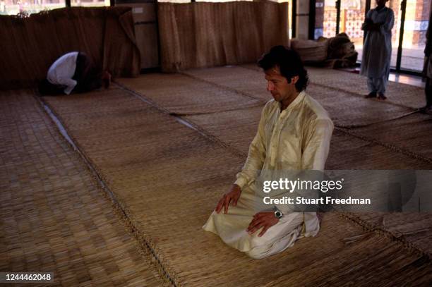 Imran Khan the former Pakistan International Cricket player at prayer in a mosque on 17th July 1999 in Lahore, Pakistan.