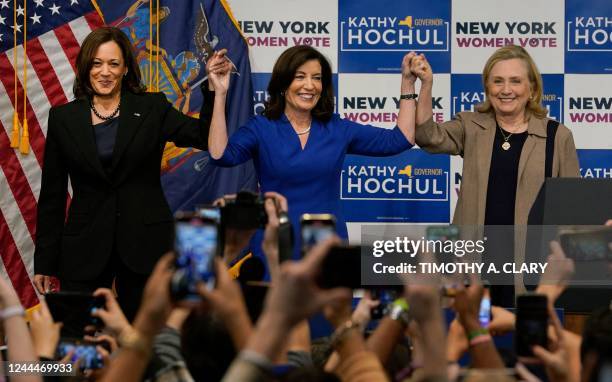 Vice President Kamala Harris , New York State Governor Kathy Hochul and former US Secretary of State Hillary Clinton stand on stage during a "Get Out...