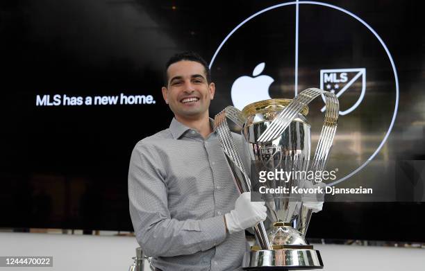 Former Philadelphia Union player and MLS great Morgan Langley holds the MLS Cup trophy at the Apple retail store during an event to celebrate the...