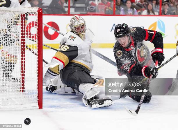 Drake Batherson of the Ottawa Senators trips as he takes a shot against Logan Thompson of the Vegas Golden Knights at Canadian Tire Centre on...