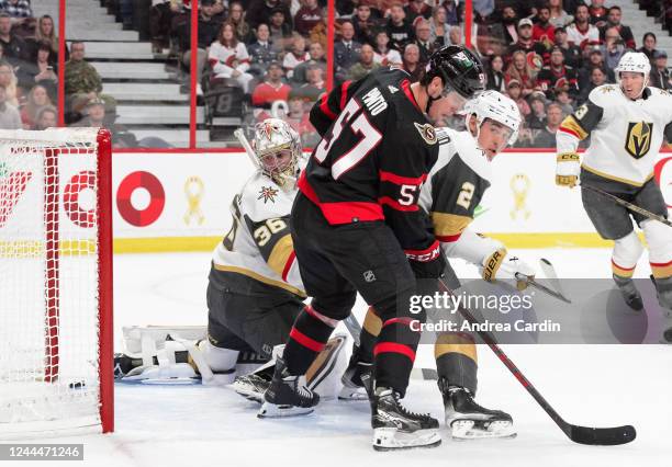 The puck hits the post behind Logan Thompson of the Vegas Golden Knights as Zach Whitecloud battles for position against Shane Pinto of the Ottawa...