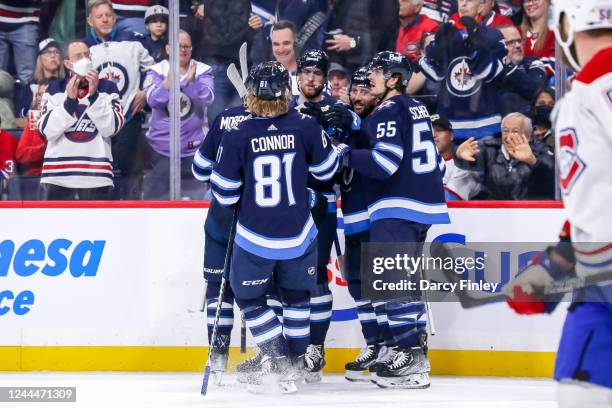 Josh Morrissey, Kyle Connor, Pierre-Luc Dubois, Sam Gagner and Mark Scheifele of the Winnipeg Jets celebrate a first period goal against the Montreal...