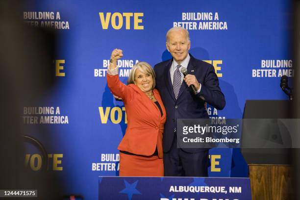 President Joe Biden, right, and Michelle Lujan Grisham, governor of New Mexico, on stage during a New Mexico Democrats rally in Albuquerque, New...