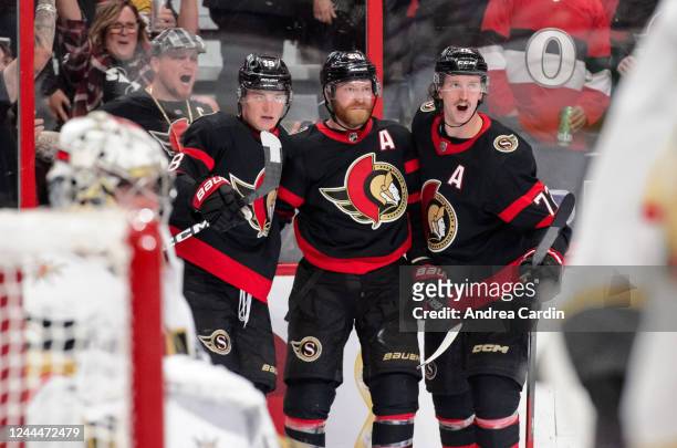 Tim Stützle of the Ottawa Senators celebrates his third period goal against the Vegas Golden Knights with teammates Thomas Chabot and Claude Giroux...