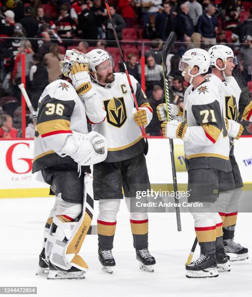 William Karlsson, Mark Stone and Logan Thompson of the Vegas Golden Knights celebrate their 5-4 win against the Ottawa Senators at Canadian Tire...