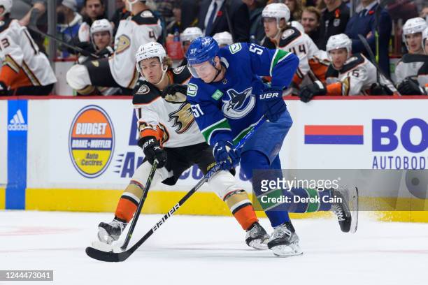 Trevor Zegras of the Anaheim Ducks and Tyler Myers of the Vancouver Canucks battle for the puck during the first period of their NHL game at Rogers...
