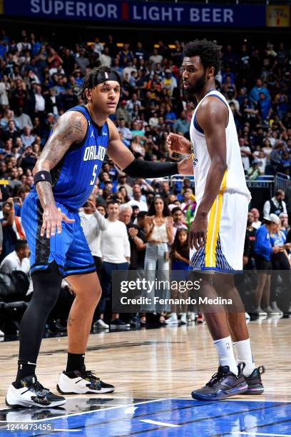 Andrew Wiggins of the Golden State Warriors and Paolo Banchero of the Orlando Magic stand on the court during the game on November 2, 2022 at Amway...