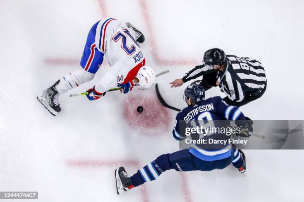 David Gustafsson of the Winnipeg Jets takes a second period face-off against Rem Pitlick of the Montreal Canadiens at the Canada Life Centre on...