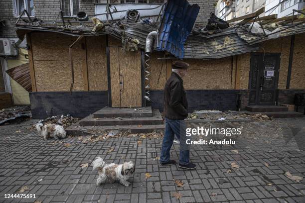 Damaged building and an old man walks with his dogs are seen after the Russian missile attacks in Mykolaiv, Ukraine on November 03, 2022.