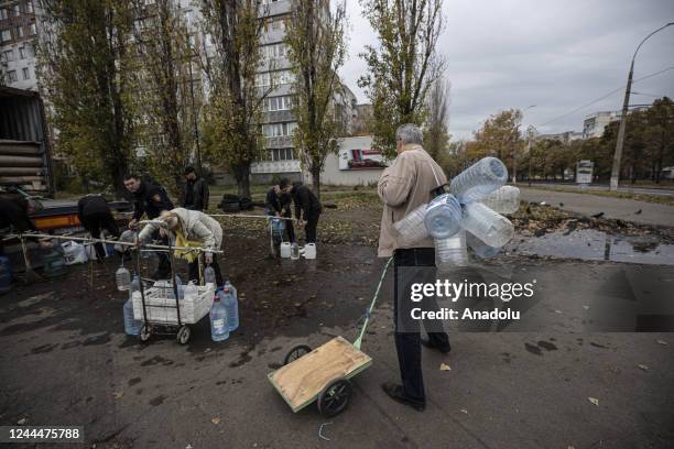 Ukrainian citizens carry bottles and buckets to receive clean water as Russia-Ukraine war continue in Mykolaiv, Ukraine on November 03, 2022. Water...