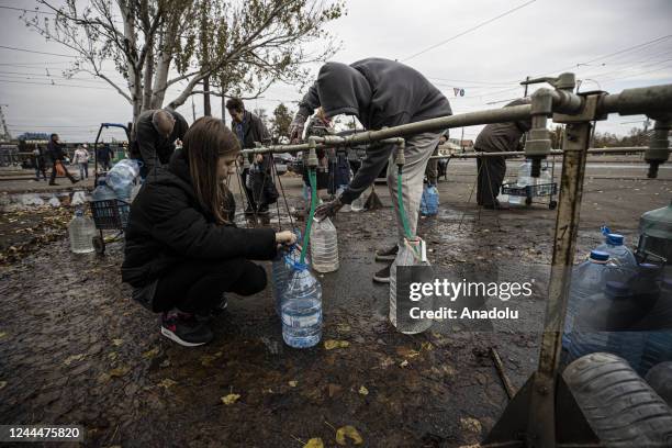 Ukrainian citizens carry bottles and buckets to receive clean water as Russia-Ukraine war continue in Mykolaiv, Ukraine on November 03, 2022. Water...