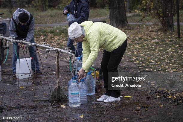 Ukrainian citizens carry bottles and buckets to receive clean water as Russia-Ukraine war continue in Mykolaiv, Ukraine on November 03, 2022. Water...