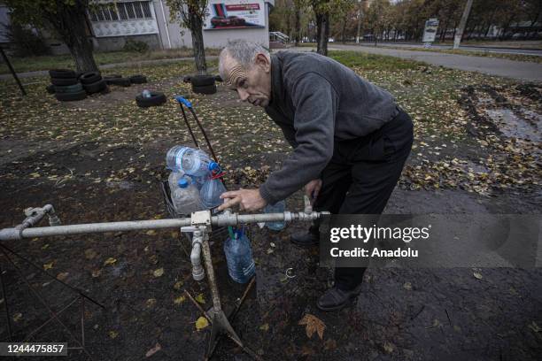 Ukrainian citizens carry bottles and buckets to receive clean water as Russia-Ukraine war continue in Mykolaiv, Ukraine on November 03, 2022. Water...