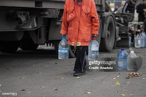 Ukrainian citizens carry bottles and buckets to receive clean water as Russia-Ukraine war continue in Mykolaiv, Ukraine on November 03, 2022. Water...