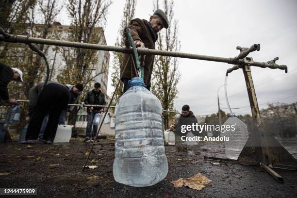 Ukrainian citizens carry bottles and buckets to receive clean water as Russia-Ukraine war continue in Mykolaiv, Ukraine on November 03, 2022. Water...