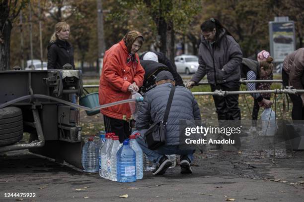 Ukrainian citizens carry bottles and buckets to receive clean water as Russia-Ukraine war continue in Mykolaiv, Ukraine on November 03, 2022. Water...