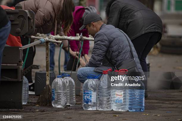 Ukrainian citizens carry bottles and buckets to receive clean water as Russia-Ukraine war continue in Mykolaiv, Ukraine on November 03, 2022. Water...