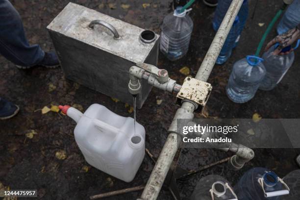 Ukrainian citizens carry bottles and buckets to receive clean water as Russia-Ukraine war continue in Mykolaiv, Ukraine on November 03, 2022. Water...