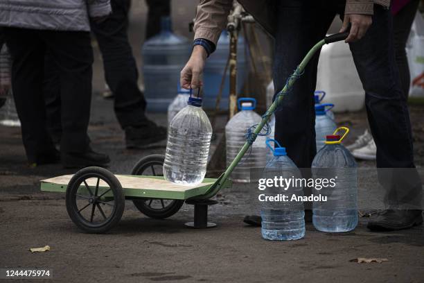 Ukrainian citizens carry bottles and buckets to receive clean water as Russia-Ukraine war continue in Mykolaiv, Ukraine on November 03, 2022. Water...