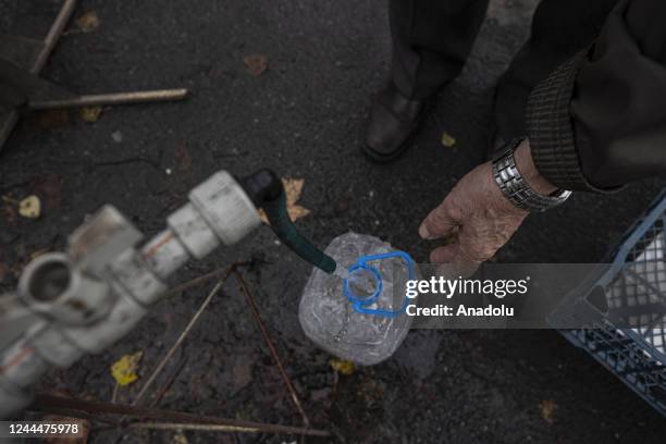 Ukrainian citizens carry bottles and buckets to receive clean water as Russia-Ukraine war continue in Mykolaiv, Ukraine on November 03, 2022. Water...