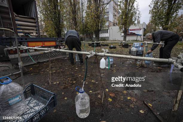 Ukrainian citizens carry bottles and buckets to receive clean water as Russia-Ukraine war continue in Mykolaiv, Ukraine on November 03, 2022. Water...