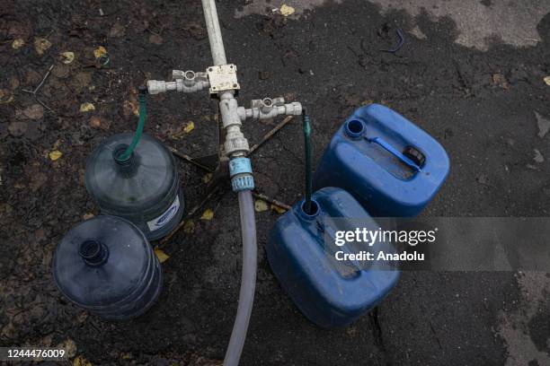 Ukrainian citizens carry bottles and buckets to receive clean water as Russia-Ukraine war continue in Mykolaiv, Ukraine on November 03, 2022. Water...