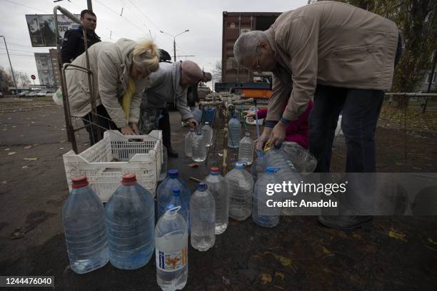 Ukrainian citizens carry bottles and buckets to receive clean water as Russia-Ukraine war continue in Mykolaiv, Ukraine on November 03, 2022. Water...