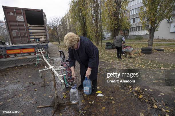 Ukrainian citizens carry bottles and buckets to receive clean water as Russia-Ukraine war continue in Mykolaiv, Ukraine on November 03, 2022. Water...