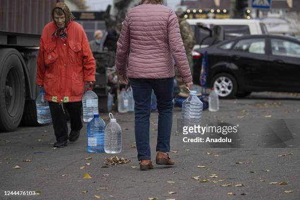 Ukrainian citizens carry bottles and buckets to receive clean water as Russia-Ukraine war continue in Mykolaiv, Ukraine on November 03, 2022. Water...