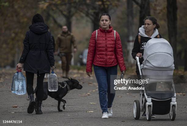 Ukrainian citizens carry bottles and buckets to receive clean water as Russia-Ukraine war continue in Mykolaiv, Ukraine on November 03, 2022. Water...