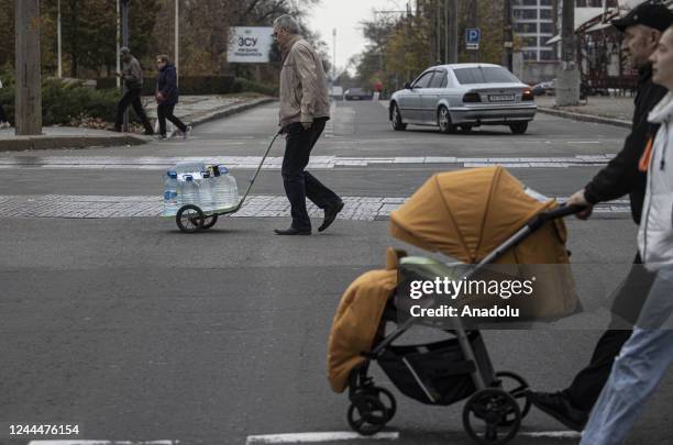 Ukrainian citizens carry bottles and buckets to receive clean water as Russia-Ukraine war continue in Mykolaiv, Ukraine on November 03, 2022. Water...