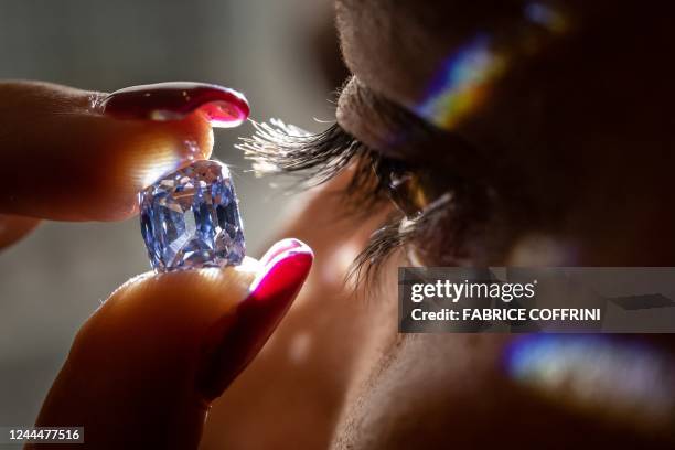 Model holds a De Beers cushion brilliant-cut fancy vivid blue 5.53 carats diamond that could fetch 15 million US dollars during a press preview by...