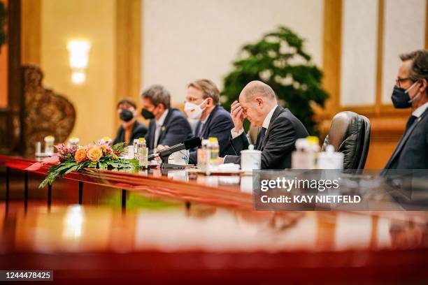 Visiting German Chancellor Olaf Scholz attends a meeting with Chinese Premier Li Keqiang at the Great Hall of the People in Beijing on November 4,...