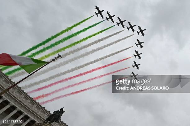Planes of the Italian Air Force aerobatic unit Frecce Tricolori spread smoke with the colors of the Italian flag as they fly over the Altare della...