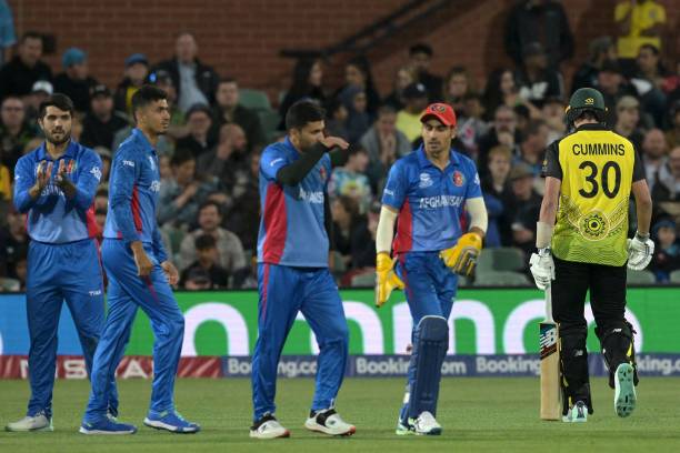 Australia's Pat Cummins departs as Afghanistan players celebrate his dismissal during the ICC men's Twenty20 World Cup 2022 cricket match between...