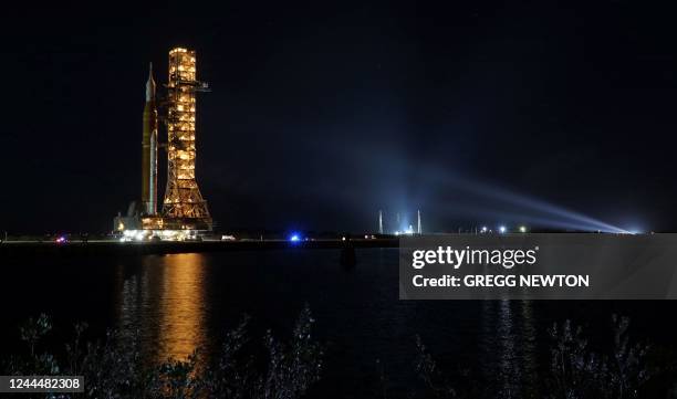 The Artemis-1 rocket is rolled out from the Vehicle Assembly Building en route to Launch Pad 39B shortly after midnight at the Kennedy Space Center...