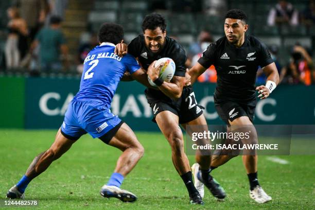 New Zealand's Sione Molia is tackled by SAmoa's Vaa Apelu Maliko on the first day of the Hong Kong Sevens rugby tournament on November 4, 2022.