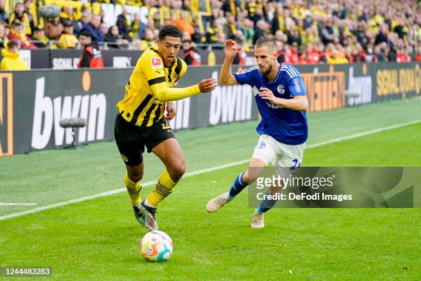 Jude Bellingham of Borussia Dortmund and Tobias Mohr of FC Schalke 04 battle for the ball during the Bundesliga match between Borussia Dortmund and...