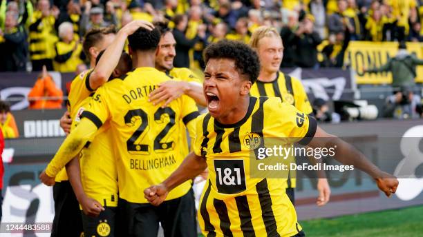 Karim Adeyemi of Borussia Dortmund celebrates after scoring his team's first goal with teammates during the Bundesliga match between Borussia...