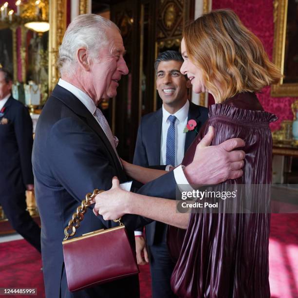 Britain's King Charles III speaks with Britain's Prime Minister Rishi Sunak and British fashion designer Stella McCartney during a reception at...