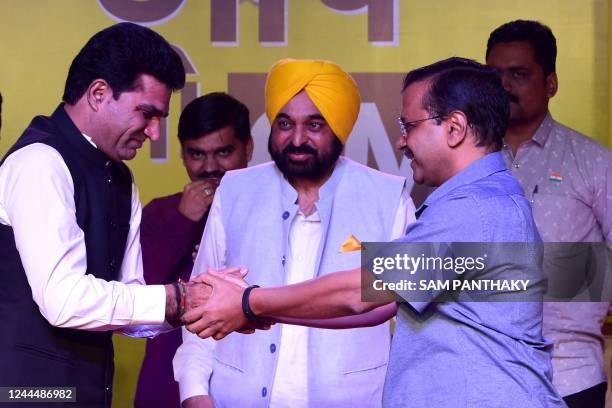 Aam Aadmi Party Chief, and Delhi cheif minister, Arvind Kejriwal greets Isudan Gadhvi after he was named as partys chief ministerial candidate in...