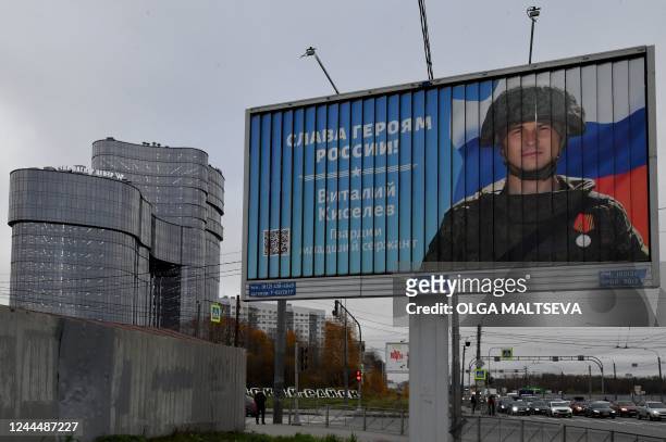 This general view taken on November 4 shows a poster displaying a Russian soldier with a slogan reading 'Glory to the Heroes of Russia' decorating a...