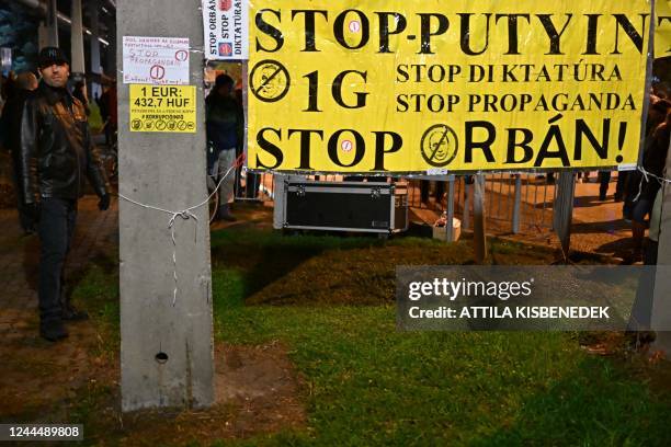 Banner reading 'Stop Putin - Stop the dictatorship - Stop propaganda - Stop Orban!' is displayed during a demonstration for an independent news...