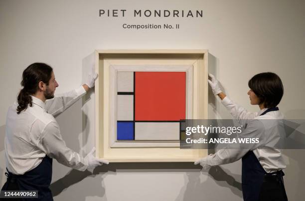 Art handlers straighten Piet Mondrian's "Composition No. II" during a press preview for Sotheby's November auctions of Modern & Contemporary art in...